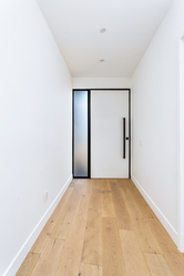 Minimal hallway with a tall flush interior door