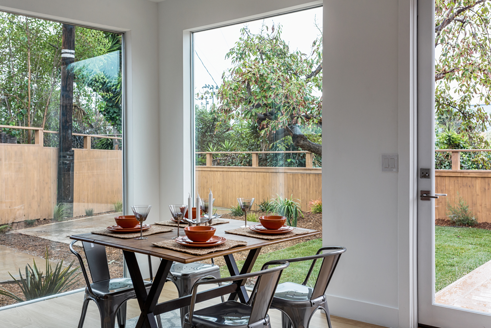 Dining area with floor-to-ceiling windows overlooking the private backyard at 3731 Toland Way in Northeast Los Angeles.