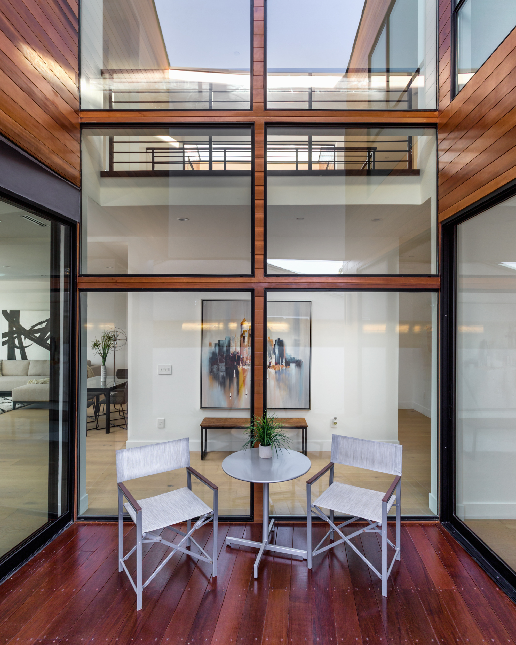 Double-height black steel-framed windows and doors